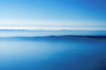 A horizon of blue mountains at dawn