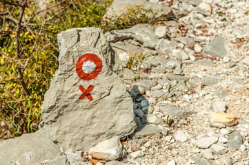Croatian trail marker on a boulder