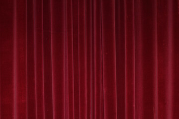 Vertical fold on red velvet curtains for background and design. Soft focus