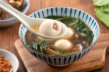 Eating big tangyuan yuanxiao with savory soup in Taiwan.