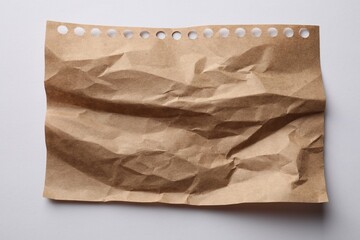 Crumpled sheet of paper on white background, top view