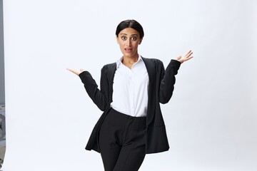 Business woman in black business suit shows signals gestures and emotions on white background, freelancer job online time management, teacher science