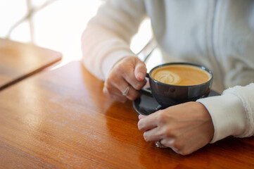 Fototapeta na wymiar hot latte art coffee on wood table, relax time