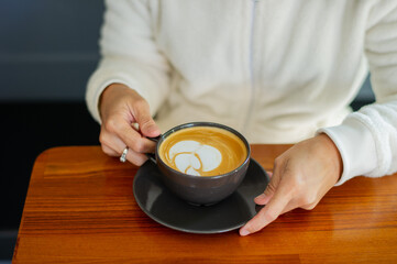 Fototapeta na wymiar hot latte art coffee on wood table, relax time