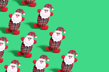 Pattern with Santa Claus ornaments on a green background with free space. Christmas and New Year concept.