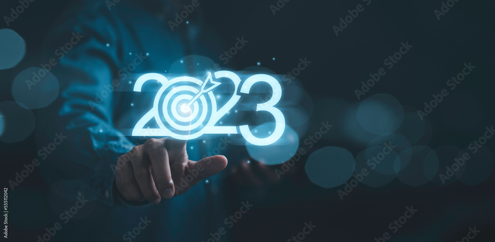Poster businessman touching to glowing 2023 with dartboard for setup new business objective target and goal