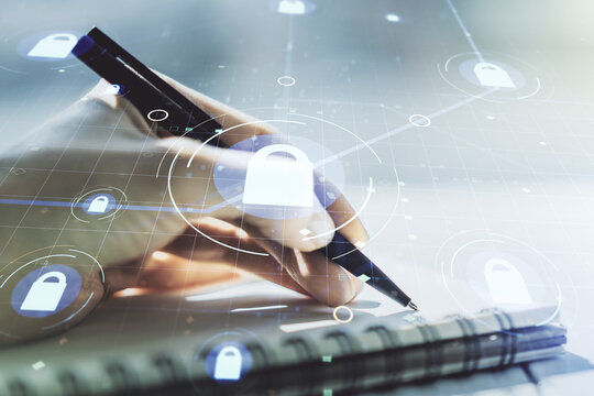 Creative idea concept with lock symbol and microcircuit illustration and with woman hand writing in notebook on background. Protection and firewall concept. Multiexposure