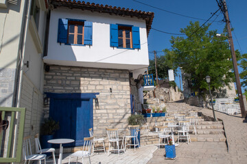 Fototapeta na wymiar Traditional Greek restaurant with blue and white walls and window shutters in a Greek Village
