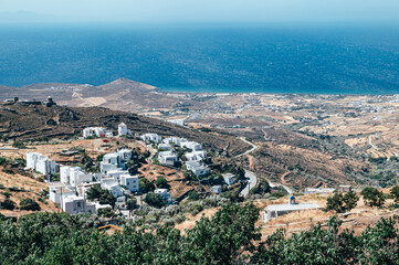 Bay and village of Tinos Island with Cycladic houses, crystal clear water of the Aegean Sea on Tinos island, Cyclades, Greece