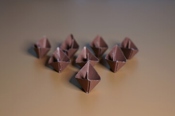 A group of paper boats on a brown background. Business concepts. Teamwork.