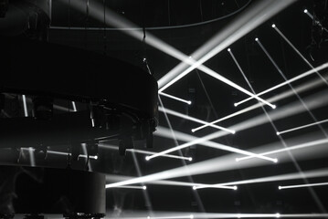 Concert light on stage. Black and white background with concert light equipments. Dark modern party...