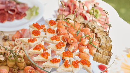 red caviar and salmon rolls with cottage cheese on the holiday table