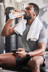 Water bottle, black man in gym and smartphone for social media after fitness exercise, healthy sports workout and muscle growth. Wellness work out, training motivation and a tired guy drinking water
