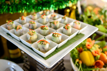 Close-up of spring roll snacks with vegetables and cheese