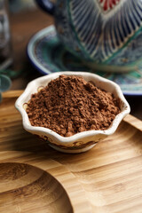 Cocoa powder in a clay bowl. Ingredients and spices for cooking