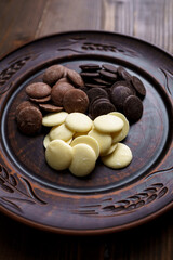 Dark and white chocolate on a clay plate