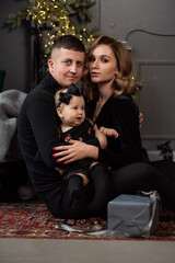 Family portrait. Christmas mood. Dark background