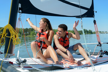 a couple on a sailboat asking for help