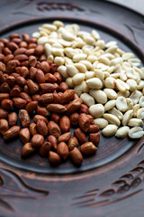 Raw peanuts in a clay bowl. Cajour and shelled beans