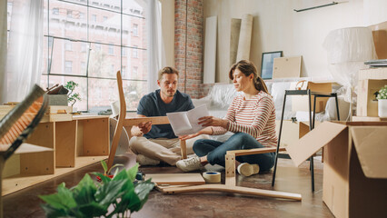 Family Moving in and Home Renovations: Happy Couple Assembles Furniture as a Team, Girlfriend Reads Instructions and Boyfriend Follows them with some Force. New Apartment for Young Partners in Love