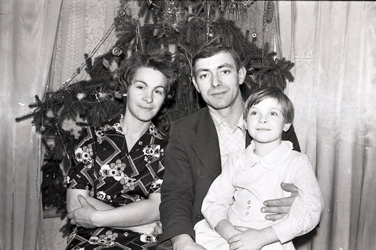 old scanned black and white photo from the family archive, families near the Christmas tree