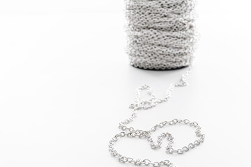 coil of decorative silver chain isolated on white background