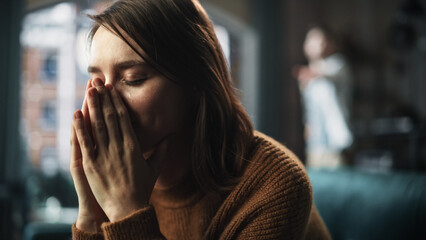 Portrait of Sad Crying Woman being Harrased and Bullied by Her Partner. Couple Arguing and Fighting Violently. Domestic Violence and Emotional Abuse. Rack Focus with Boyfriend Screaming in Background - obrazy, fototapety, plakaty