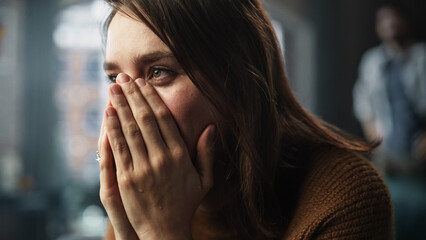 Sad Woman being Harrased and Bullied. Couple Arguing, Fighting, Domestic Violence, Abuse. Cinematic Rack Focus Switching Between Girlfriend Closeup Portrait and Boyfriend Screaming in Background