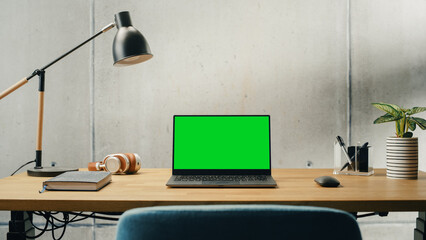 Laptop Computer with Mock Up Green Screen Display Standing on a Desk. Efficiently Minimalistic...