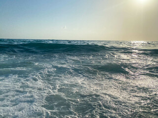 Waves, splashes of water on the beach at the sea on vacation in a tourist warm eastern tropical country southern paradise resort on vacation. The background