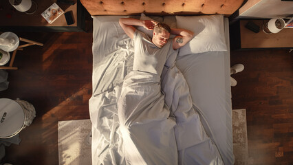 Top View Apartment: Handsome Young Man Sleeps in His Bed, Turns off Alarm Clock on Smartphone,...