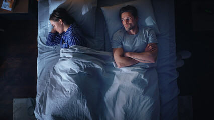 Top View Apartment Bedroom: Quarrelling Young Couple in the Bed at Night. Young People After a...