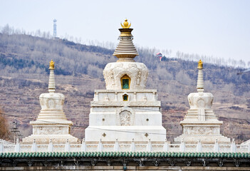  A white Buddhist stupa or pagoda in a Tibetan monastery, Tibet. 