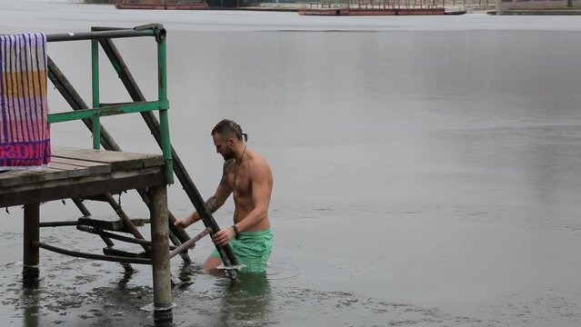 Bathing in icy water. Diving into icy water. Ice Swimming. Bathing in the ice-hole. 