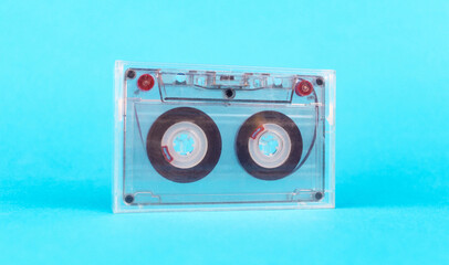 Audio cassette in a case on a blue background