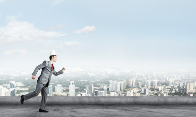 King businessman in elegant suit running on building roof and business center at background