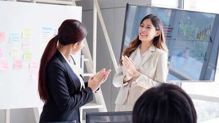 business woman and colleagues clapping to congratulate new employee, business concept.
