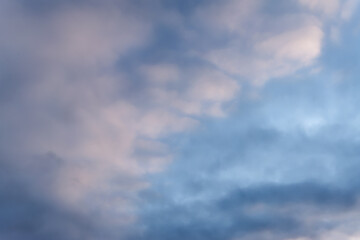 Summer evening sky in the picturesque clouds, lit by the rays of the setting sun.