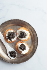 Black caviar and appetizers mini pancakes top view