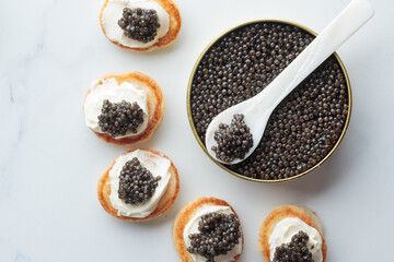 Black caviar and appetizers mini pancakes top view
