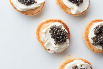 Black caviar appetizers mini pancakes top view