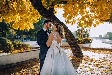 bride and groom dance in a park