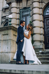 bride and groom in front of city hall