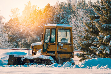 Bulldozer standing on the snow in winter