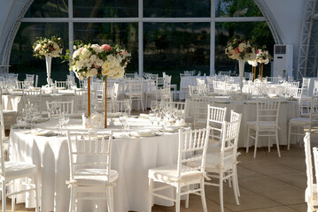  Tent for a wedding banquet. Large tent with tables and chairs. Wedding decorations.