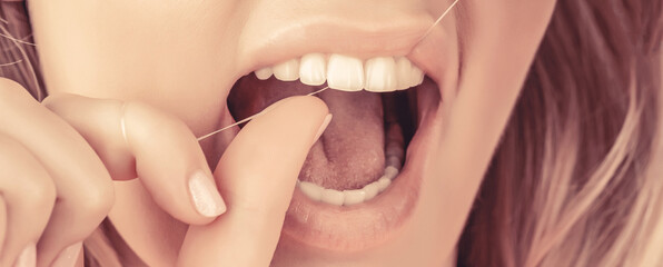 Smiling women use dental floss white healthy teeth. Dental flush - woman flossing teeth