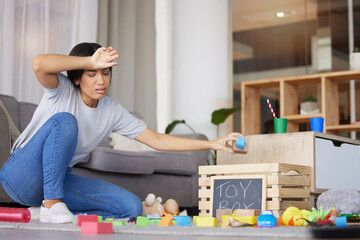 Toys, mother tired and headache for cleaning, messy living room and exhausted. Woman, clean...