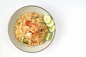 Thai fried rice with shrimp, egg, tomato, green onion, lime and chopsticks on a white background, top view. Thai food top view. 