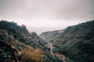 a scenic view of a mountain with a river running through it on madeira