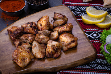 Shish Tawook, tawouk, tikka boti with lemon served in dish isolated on table top view of arabic food